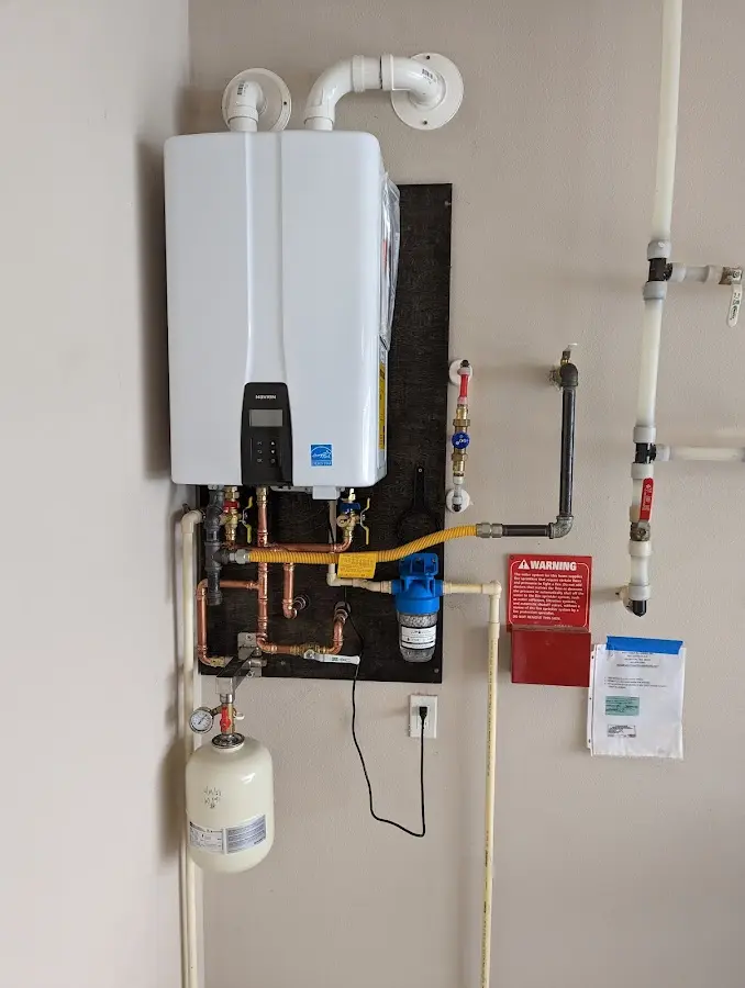 Professional plumber installing copper piping in a Deerpark home